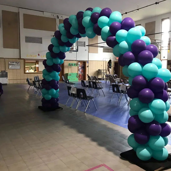 blue and purple balloon arch inside auditorium 