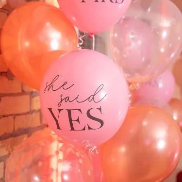 pink balloons with message she said yes