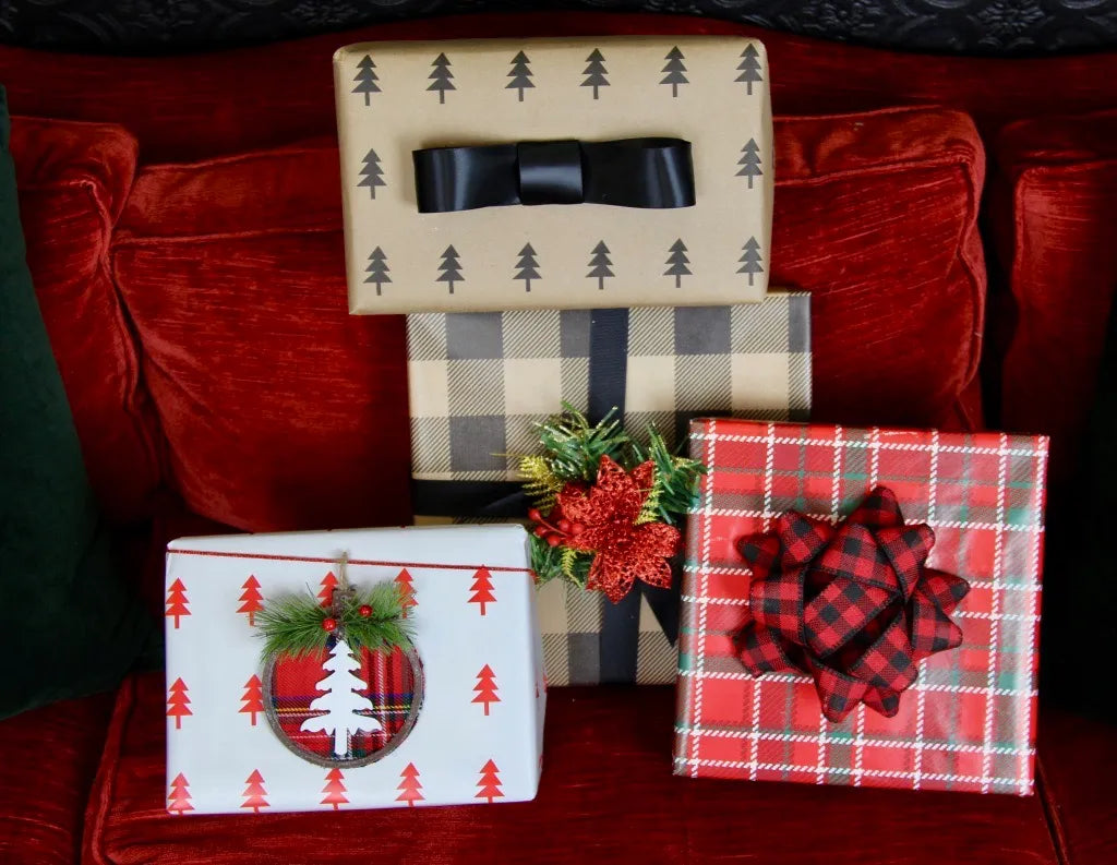four gift boxes sitting on red velvet sofa