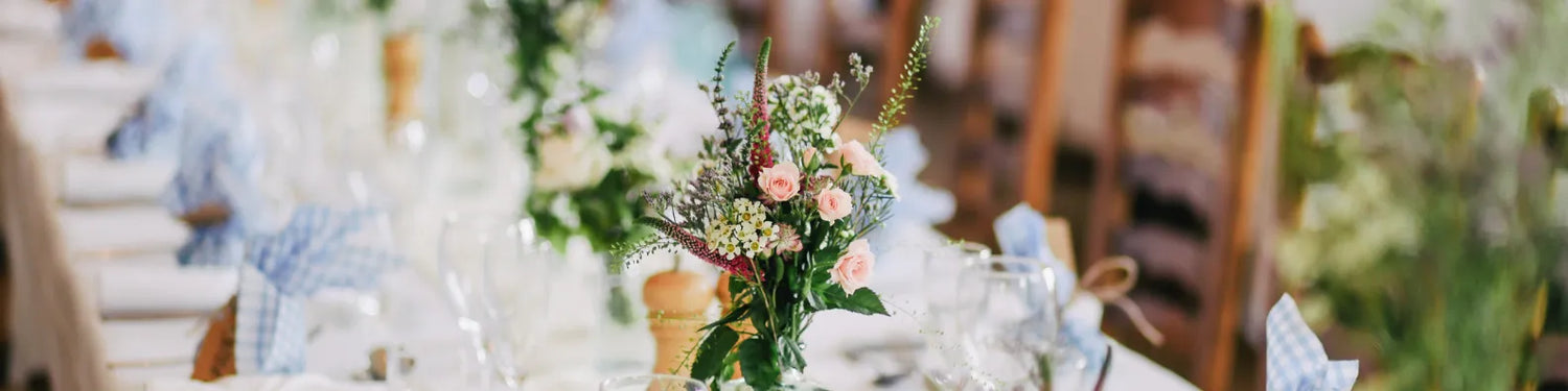 event table decorated with floral arrangement and glassware